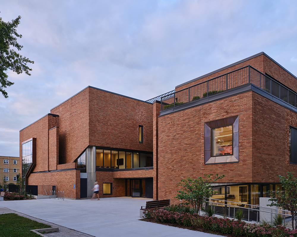 The exterior of a large brutalist brick building