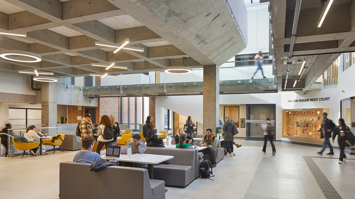 A spacious interior of an academic building with exposed concrete structure