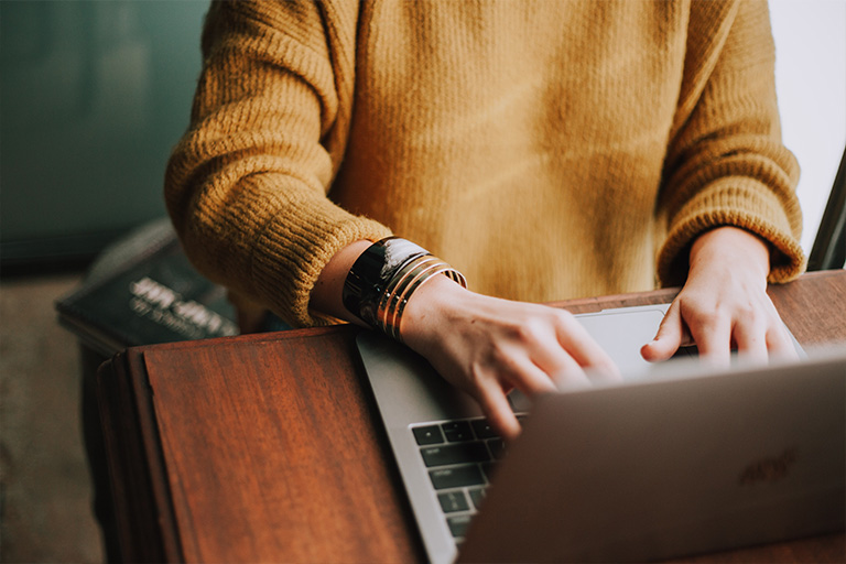 Pic of person typing on a computer