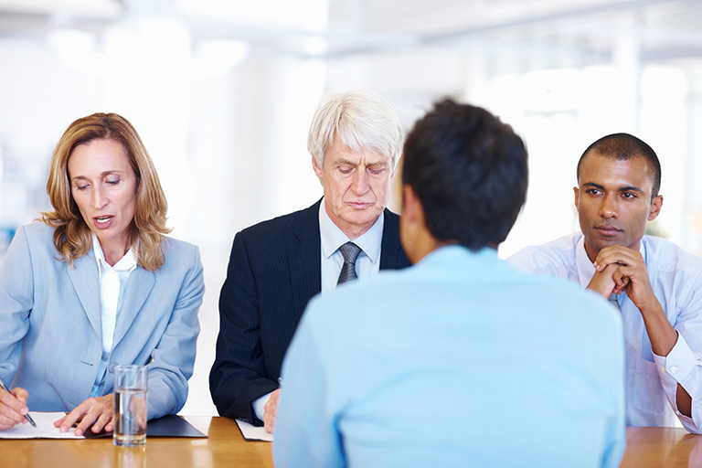 Image of four people at a table meeting