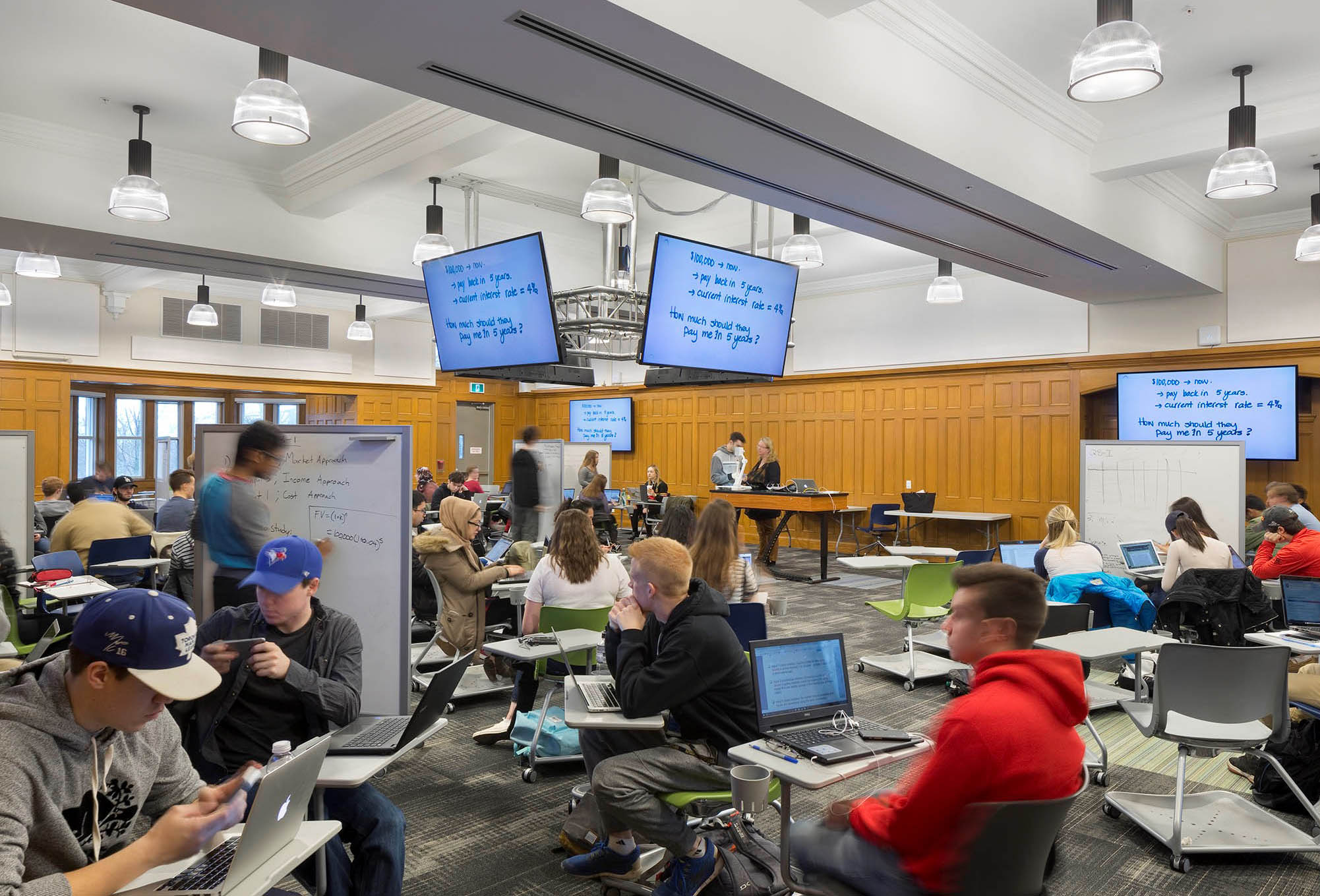 Students at desks in a large room.