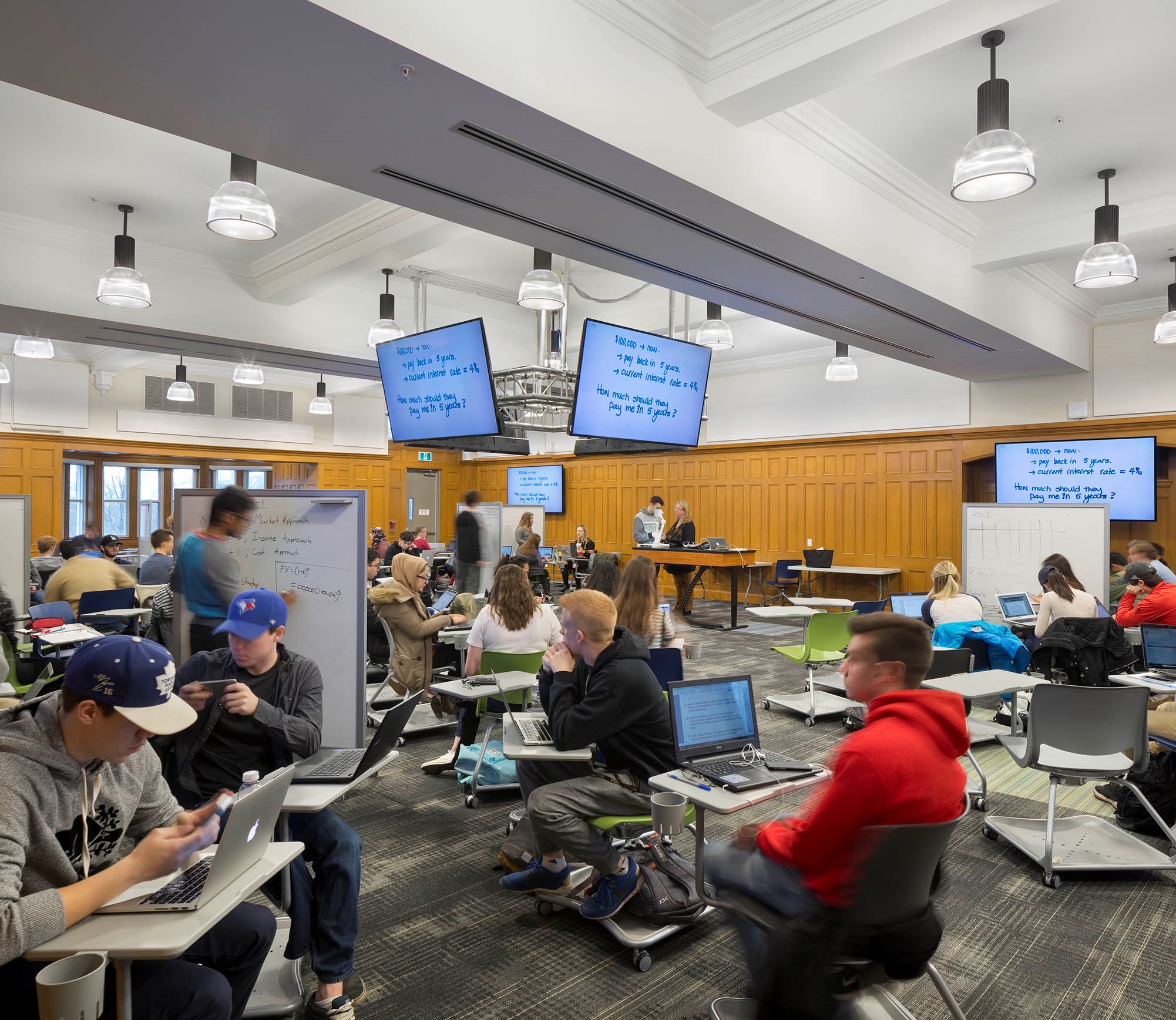 Students at desks in a large room.