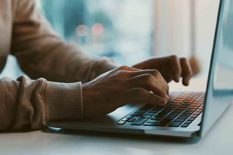 A person  searching for something on a lap top