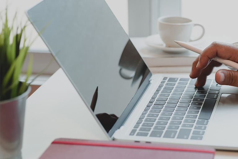 Image of  a person typing on a computer