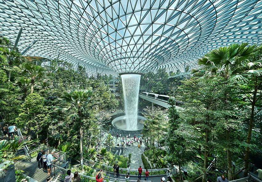 The Jewel Changi Airport, a glass-roofed interior filled with plants