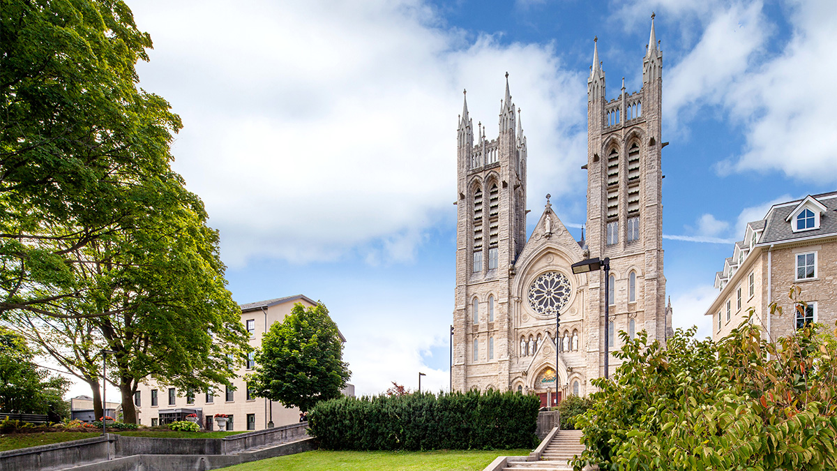 View of the basilica's prominent architecture standing on a hill, featuring its stone facade and twin towers.