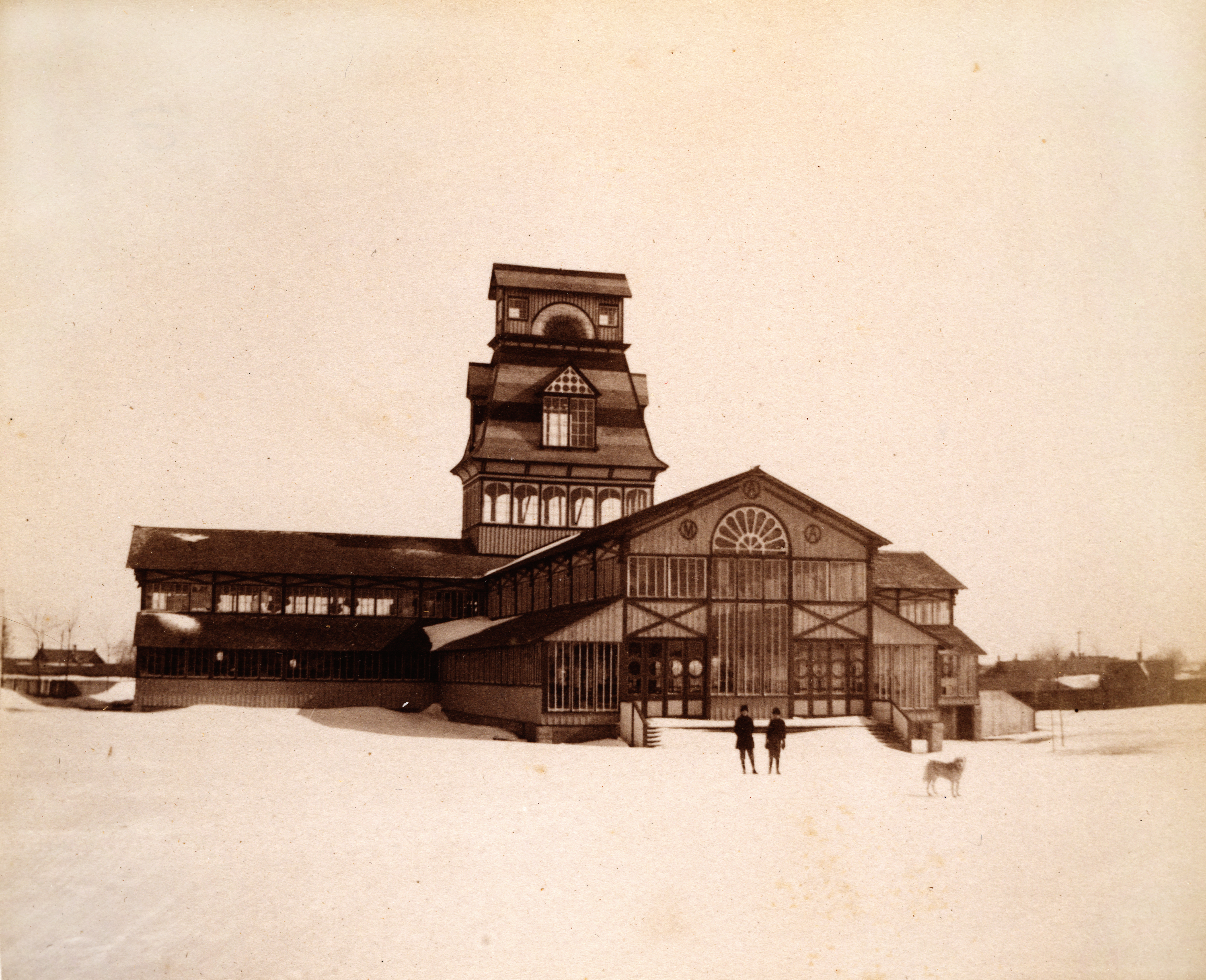 Historic photograph of Kingston's Crystal Palace, featuring intricate Victorian architecture, a central tower, and snow-covered surroundings.